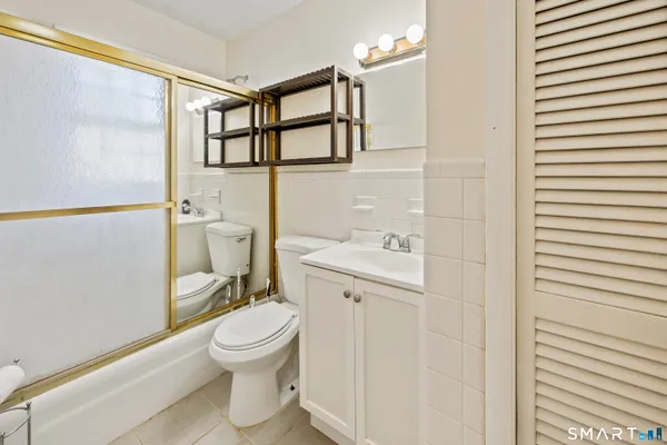 a white toilet sitting next to a bathroom sink