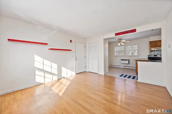 a view of a livingroom with wooden floor and a window