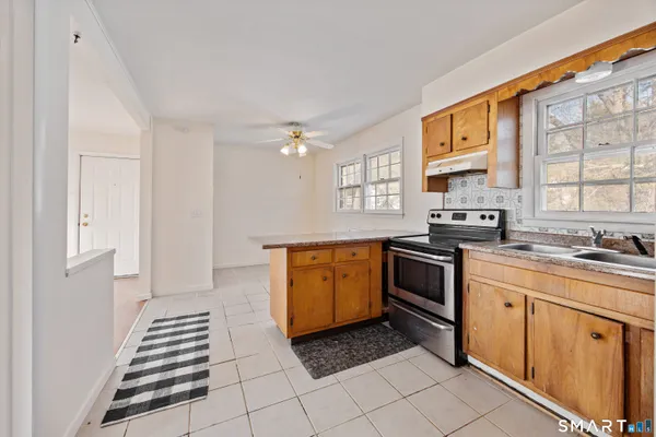 a kitchen with a stove sink and cabinets