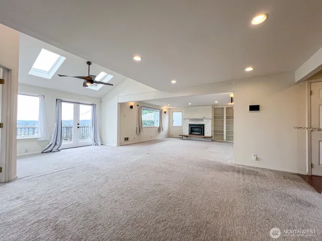 a big room with chandelier and windows