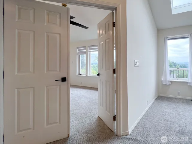 a view of a hallway with a wooden door
