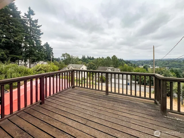 a balcony with wooden floor and fence