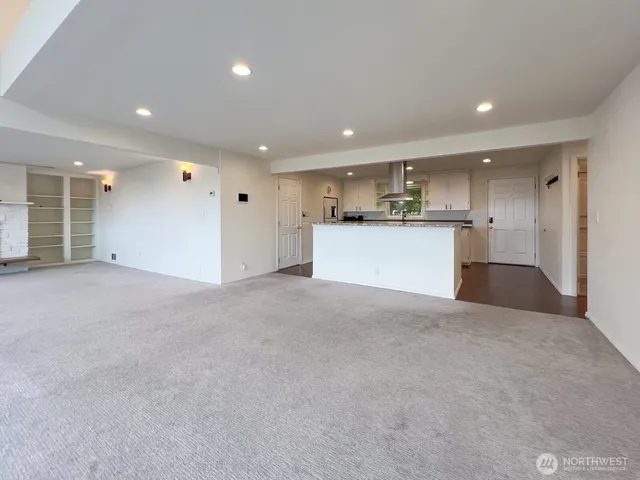 a view of a kitchen with a sink and a refrigerator