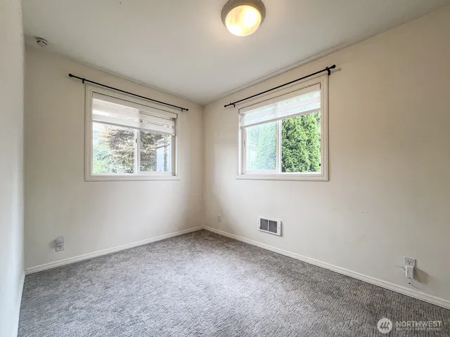 a view of an empty room with windows