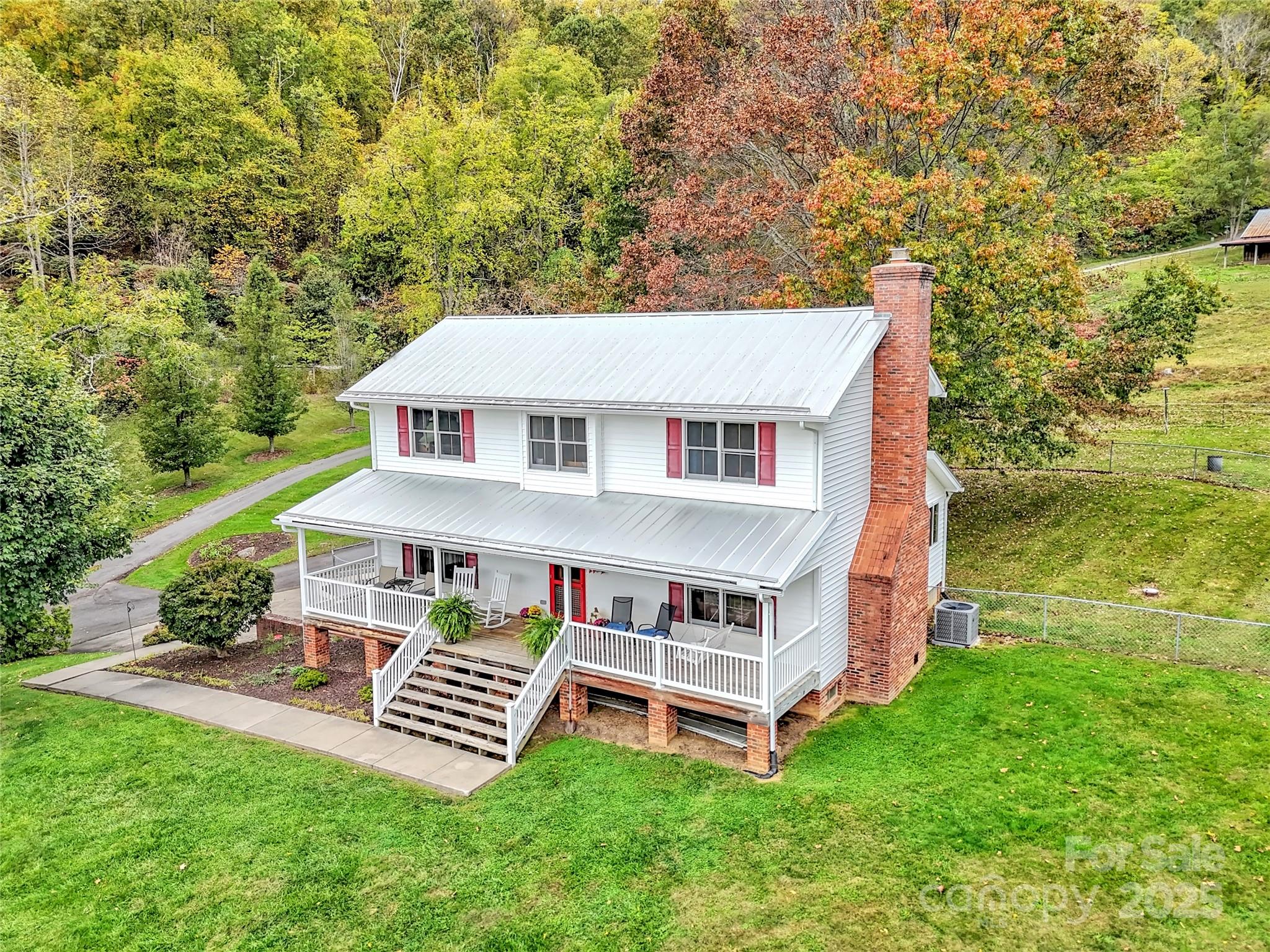 a view of a house with a yard deck and a garden