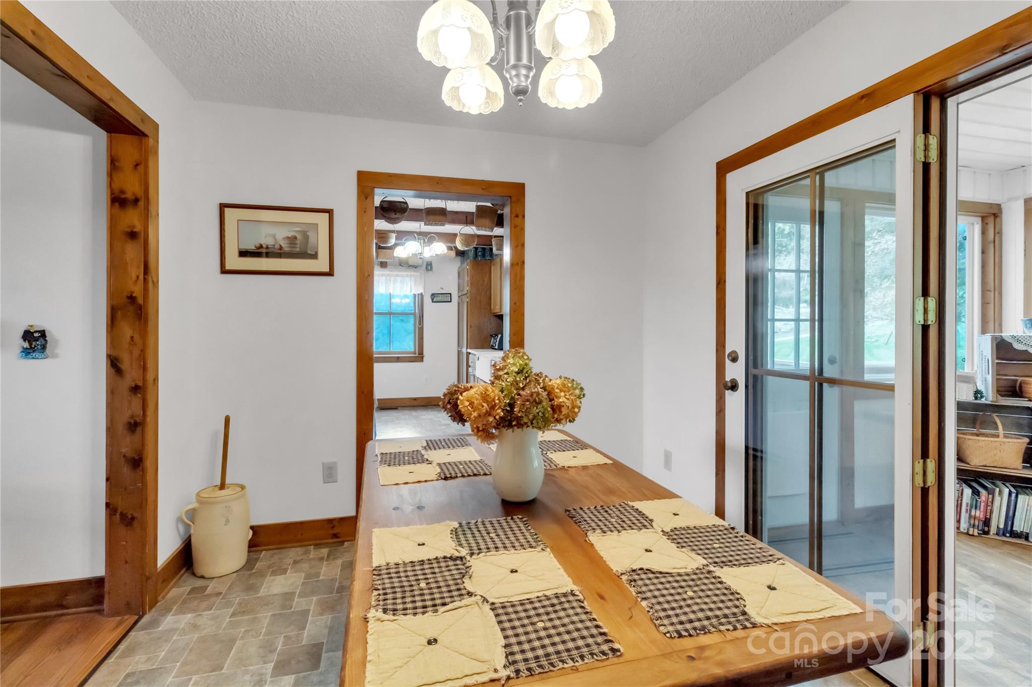 580 River Point Road Canton, NC 28716 - Photo 23 of 46 a view of a hallway that has a couch and a dining table with garden view
