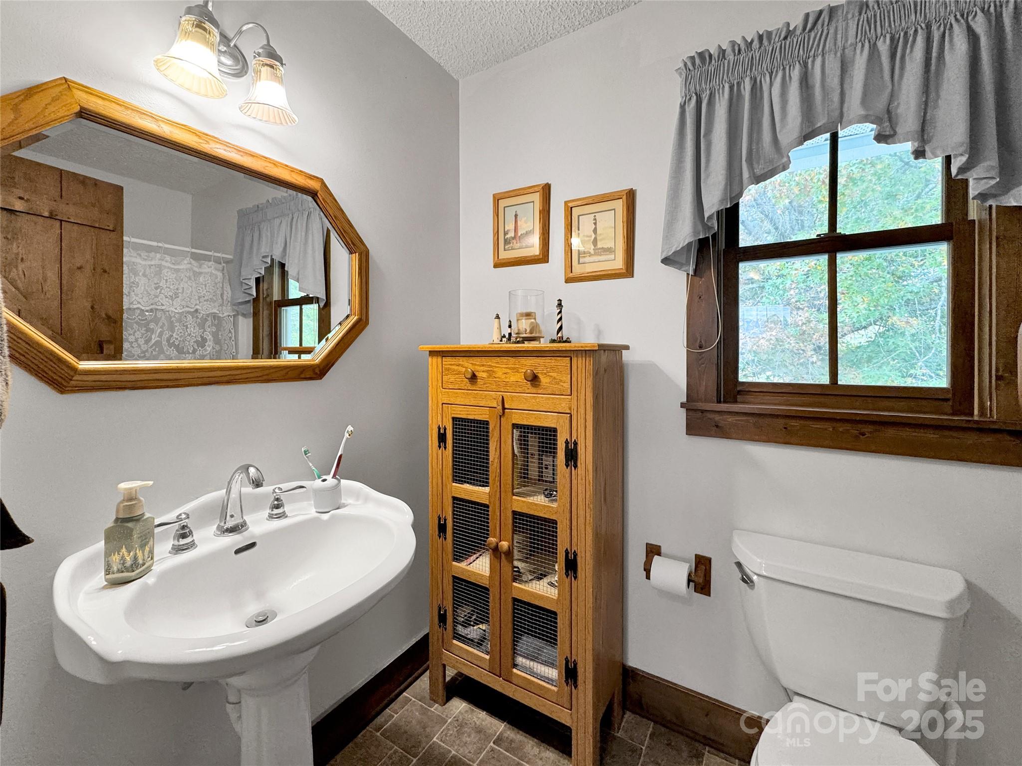 580 River Point Road Canton, NC 28716 - Photo 33 of 46 a bathroom with a sink and a mirror