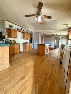 a living room with stainless steel appliances furniture and a kitchen view
