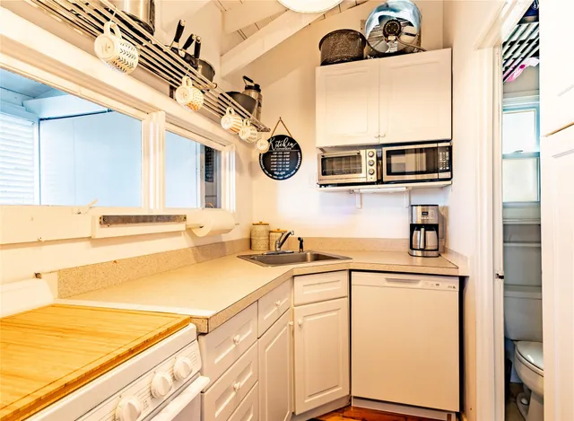 a kitchen with stainless steel appliances a sink and a cabinets