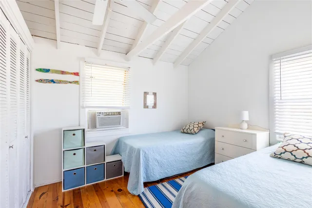a bedroom with two beds and a window