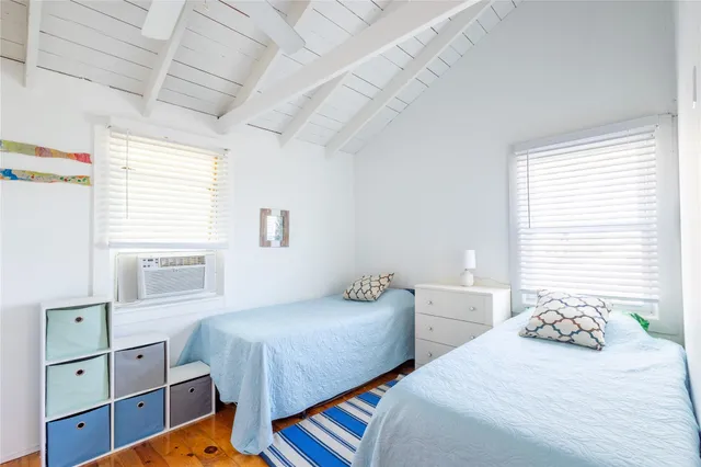 a bedroom with two beds and a window