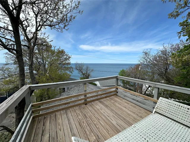 a view of balcony with wooden floor and fence