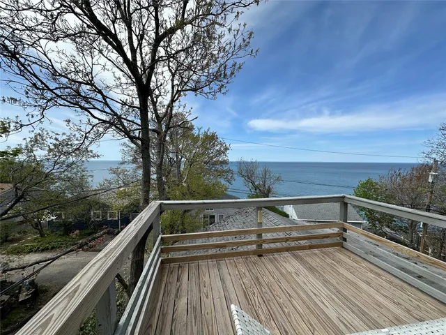 a view of roof deck with large trees