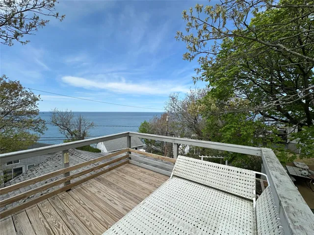 a view of balcony with wooden floor and seating space