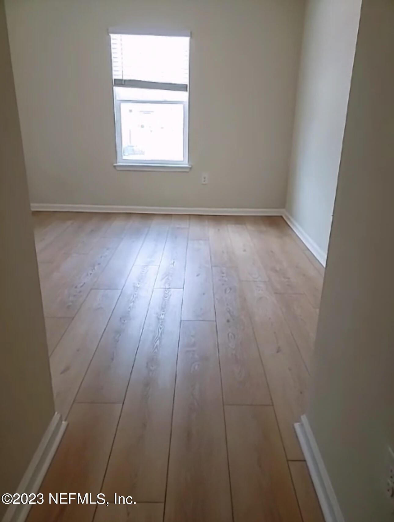 433 Pine Bluff Drive St. Augustine, FL 32092 - Photo 18 of 23 an empty room with wooden floor and windows