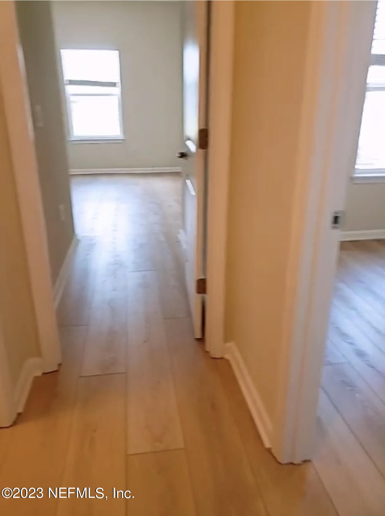 433 Pine Bluff Drive St. Augustine, FL 32092 - Photo 21 of 23 an empty room with wooden floor and windows