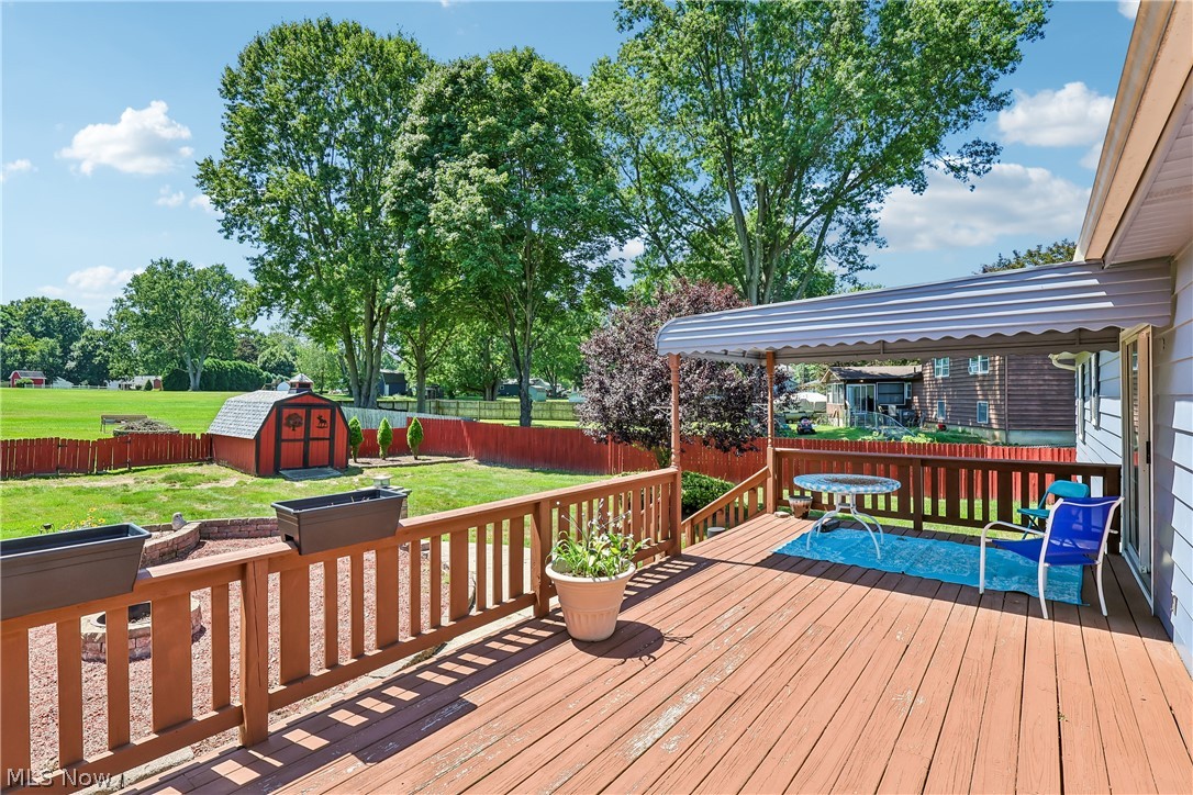 6109 North Oval Road Clinton, OH 44216 - Photo 40 of 47 Large wooden deck featuring a covered patio area with direct access to the backyard