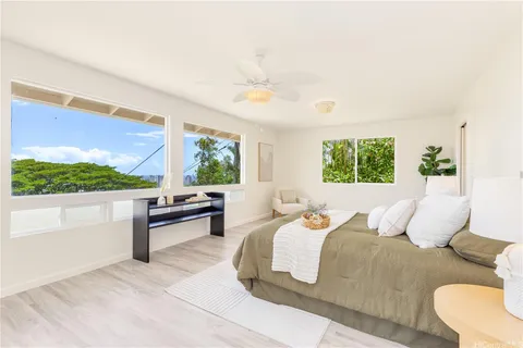 a bedroom with a bed and a large window