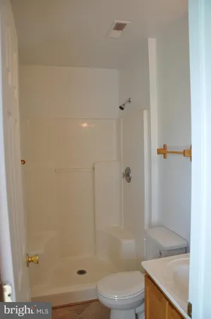 a bathroom with a shower and a toilet