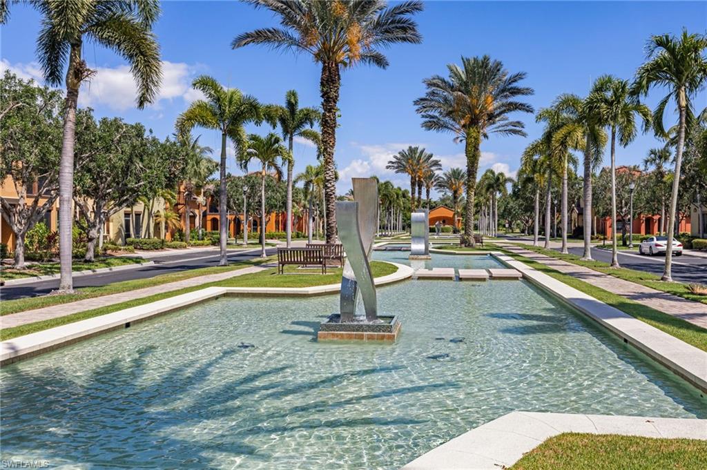 9128 Delano Street, Unit 892 Naples, FL 34113 - Photo 49 of 49 a view of a swimming pool with palm trees