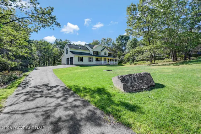 a view of house with backyard and garden