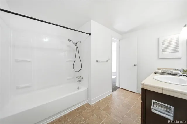 a view of a brick wall with a small yard