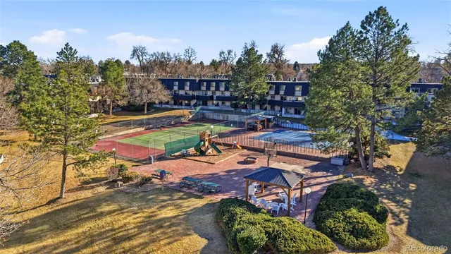 a brick building with a large tree in front