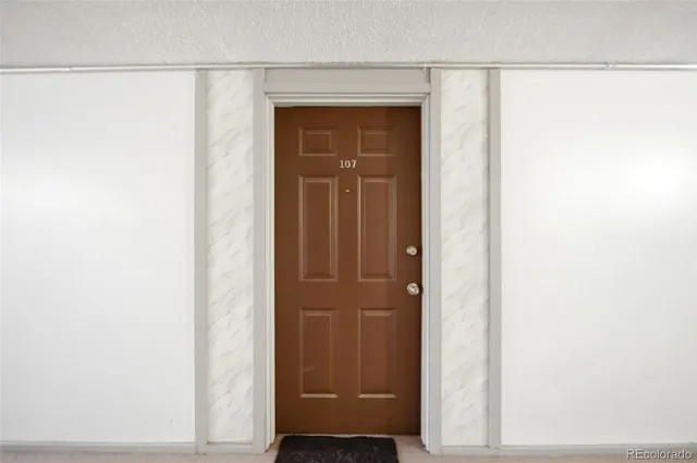 an empty room with closet and mirror