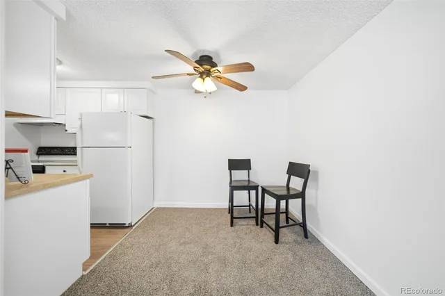 a view of a kitchen with a sink and a refrigerator