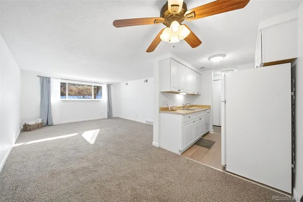 a kitchen with cabinets and refrigerator