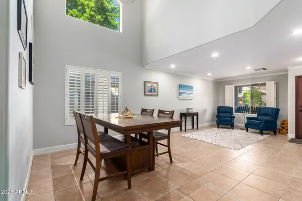 a view of a dining room with furniture and a potted plant