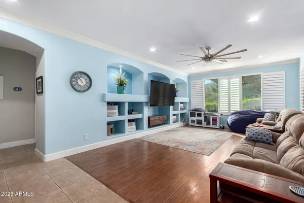 a living room with furniture a window and a clock