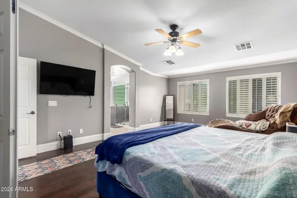 a bedroom with a bed and a flat screen tv