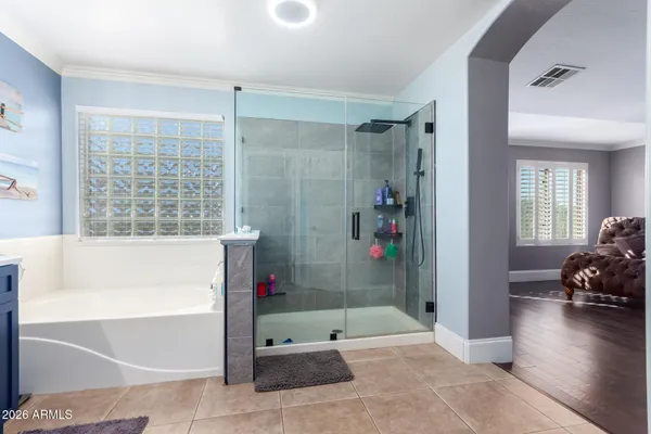a bathroom with a tub shower and window
