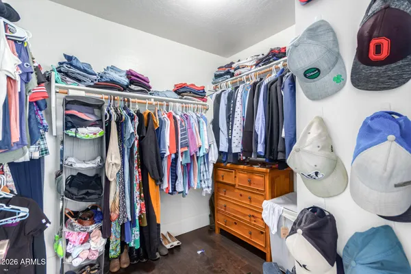 a view of walk in closet with clothes and shoes