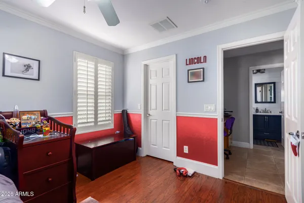 a bedroom with bed and a flat screen tv