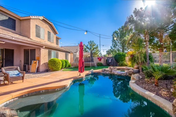 a view of a house with backyard porch and sitting area