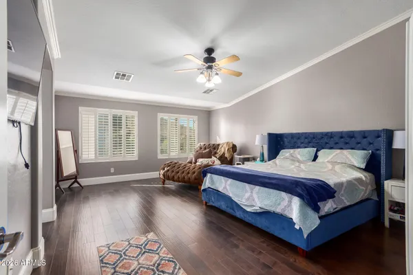 a spacious bedroom with two beds and a chandelier