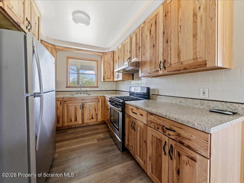 9-17 Vago Road Tunkhannock, PA 18657 - Photo 15 of 57 a kitchen with stainless steel appliances granite countertop a stove and a refrigerator