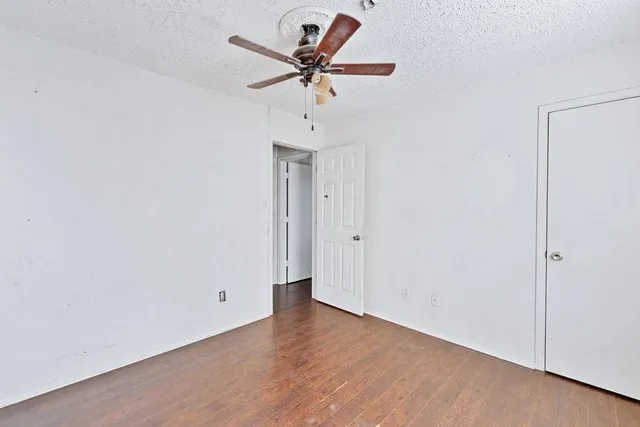 a bathroom with a granite countertop sink a toilet and shower