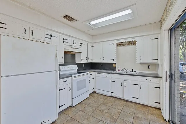 a kitchen with granite countertop cabinets stainless steel appliances and a counter space