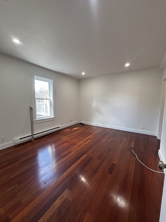 16 Cottage Street, Unit 2 Lynn, MA 01905 - Photo 21 of 25 an empty room with wooden floor and windows
