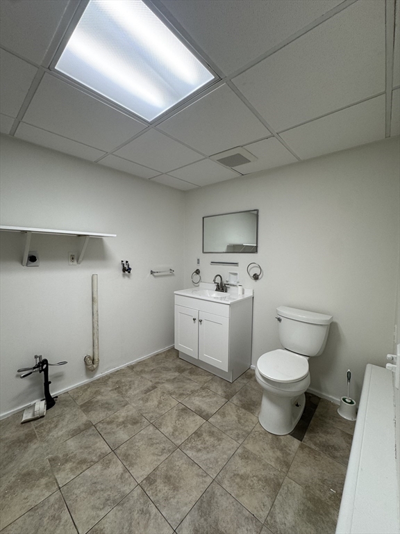 16 Cottage Street, Unit 2 Lynn, MA 01905 - Photo 23 of 25 a bathroom with a toilet sink a mirror and vanity