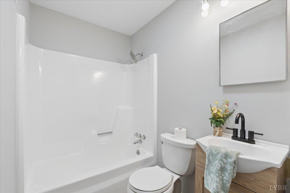 146 Watts Mill Road Pamplin, VA 23958 - Photo 13 of 37 a white toilet sitting next to a bathroom sink