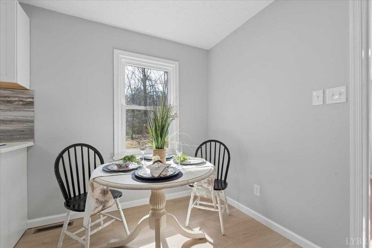 146 Watts Mill Road Pamplin, VA 23958 - Photo 14 of 37 a view of a dining room with furniture window and wooden floor