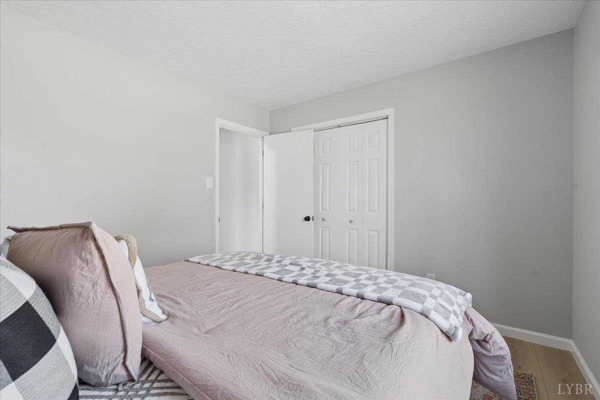 146 Watts Mill Road Pamplin, VA 23958 - Photo 16 of 37 a bedroom with a bed and a chair