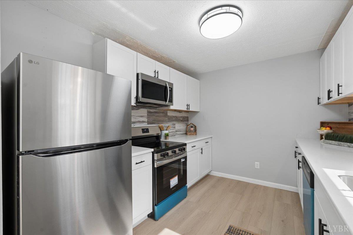 146 Watts Mill Road Pamplin, VA 23958 - Photo 17 of 37 a kitchen with stainless steel appliances granite countertop a refrigerator a stove a sink and a microwave