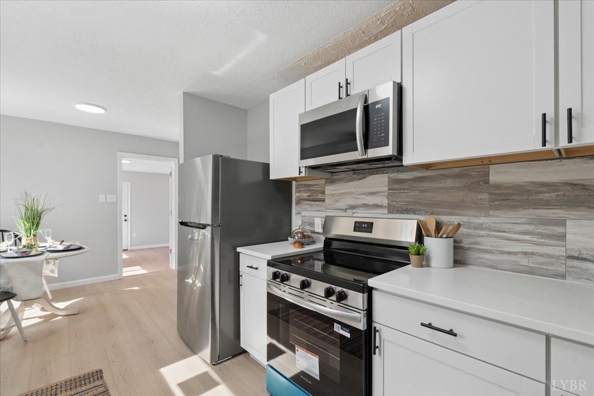146 Watts Mill Road Pamplin, VA 23958 - Photo 18 of 37 a kitchen with stainless steel appliances a stove microwave and refrigerator