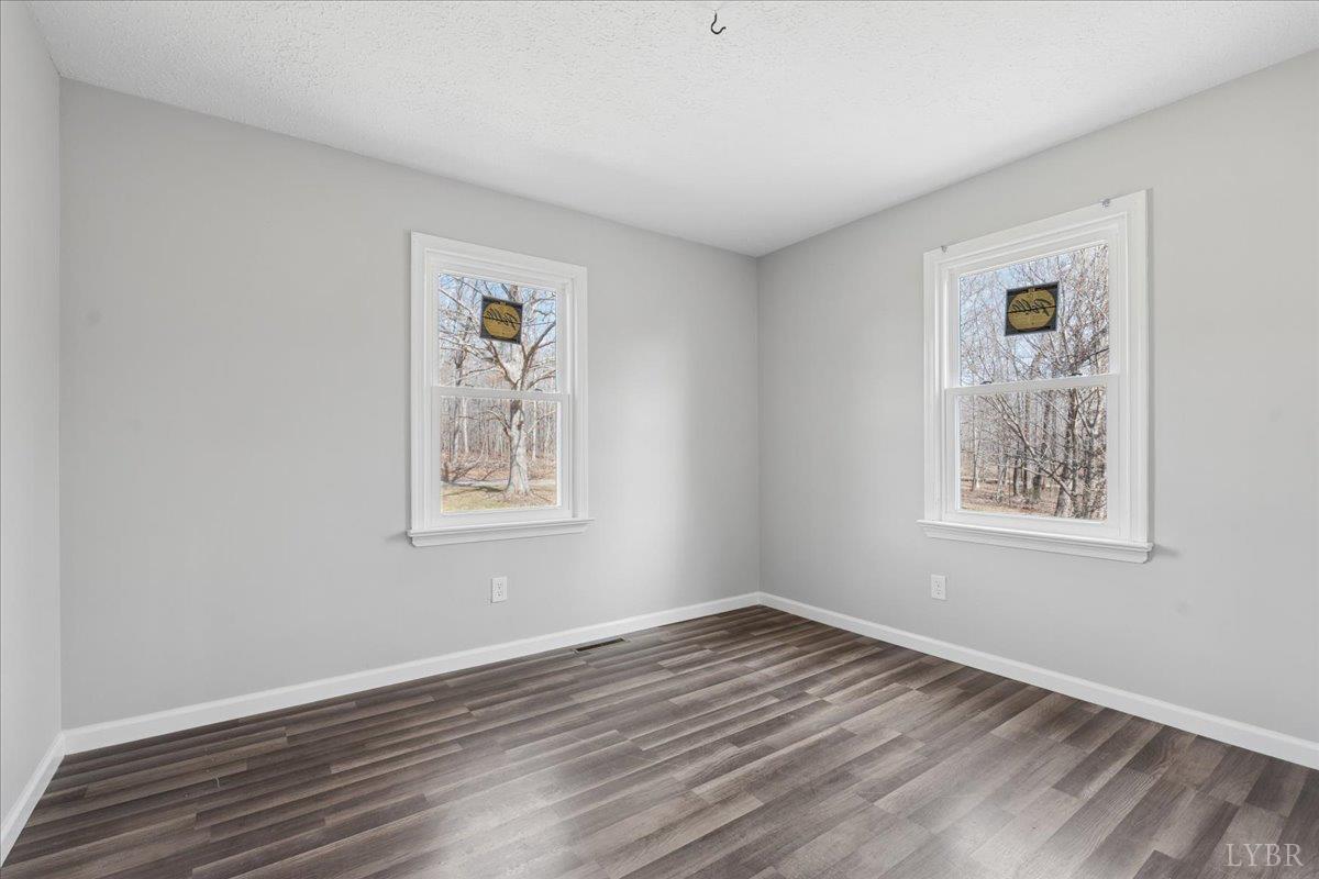 146 Watts Mill Road Pamplin, VA 23958 - Photo 19 of 37 a view of an empty room with wooden floor and a window