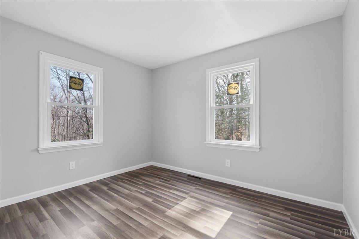 146 Watts Mill Road Pamplin, VA 23958 - Photo 21 of 37 a view of an empty room with wooden floor and a window